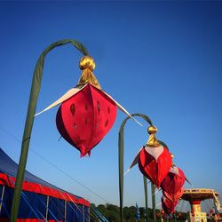 Low angle view of red hanging against sky