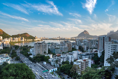 High angle view of townscape by sea against sky