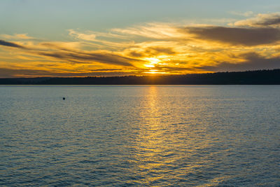 The sun set on the puget sound in burien, washington.