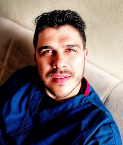 Close-up portrait of young man at home