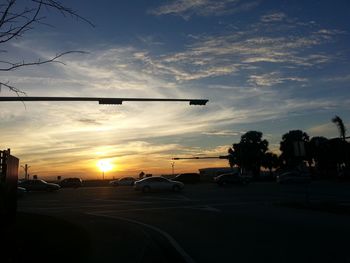 Cars on road at sunset