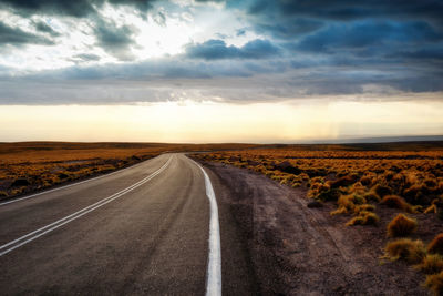 Road amidst landscape against sky during sunset