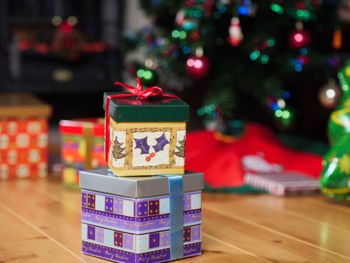 Close-up of christmas presents on hardwood floor at home