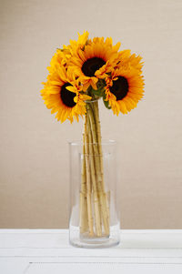 Close-up of yellow flowers in vase on table