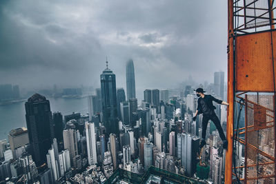 High angle shot of cityscape against clouds