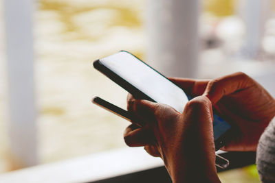 Close-up of hands using phone