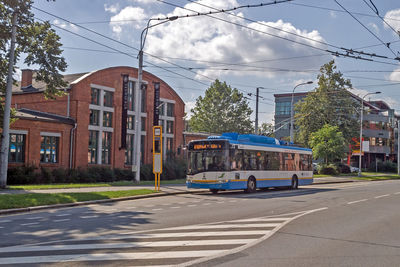 View of city street and buildings against sky