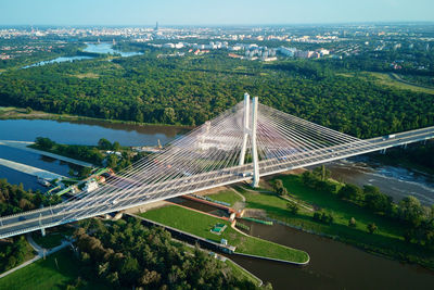 Large cable stayed bridge over river with car traffic, aerial view