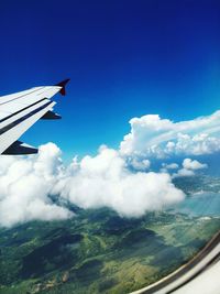 Cropped image of airplane flying against sky