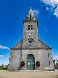 Low angle view of building against blue sky