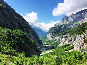 Scenic view of valley and mountains against sky