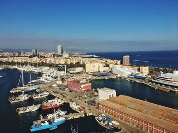 High angle view of cityscape by sea against sky