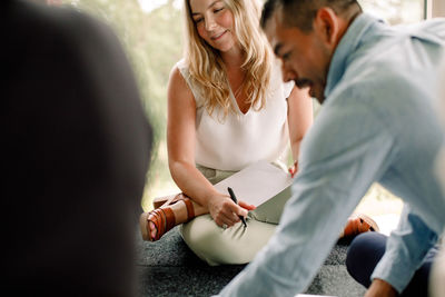 Male and female business professionals discussing during meeting at convention center