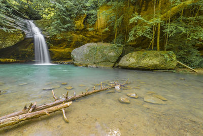 View of waterfall in forest at hocking hill ohio.