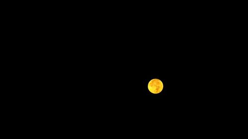 Low angle view of moon against clear sky at night