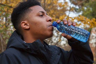 Portrait of boy drinking water