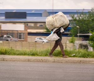 Rear view of man walking on road