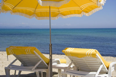 Scenic view of beach against blue sky