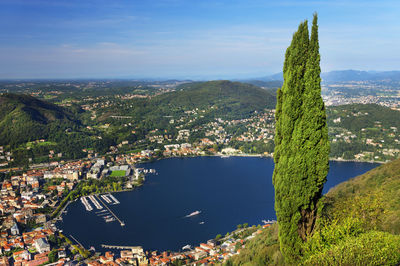 Aerial view of lake against mountains and blue sky 