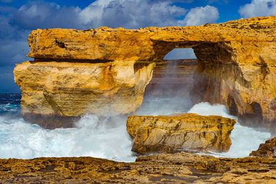 Scenic view of landscape against cloudy sky