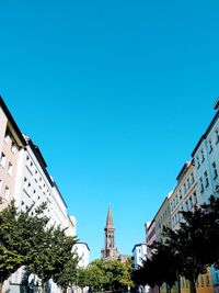 Low angle view of buildings against clear blue sky