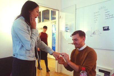 Rear view of man using smart phone