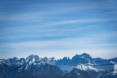 Scenic view of snowcapped mountains against blue sky