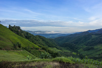 Scenic view of landscape and mountains against sky