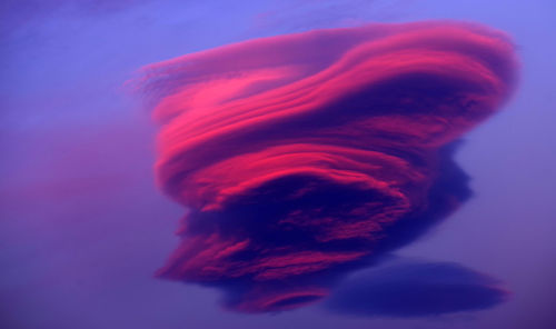 Low angle view of pink cloud against purple sky