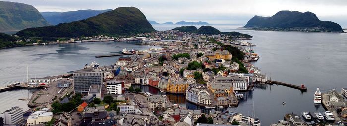 High angle view of city by sea against sky