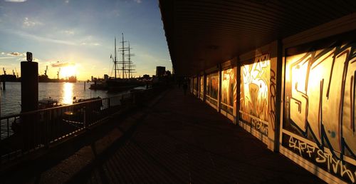 Pier on sea at sunset