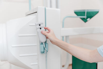 Cropped hand of nurse using medical equipment