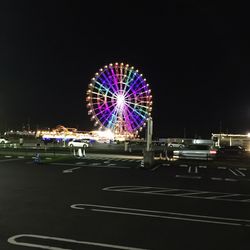 Illuminated ferris wheel at night