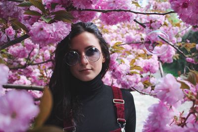Portrait of beautiful woman amidst pink flowers