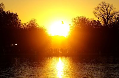 Scenic view of lake against sky during sunset