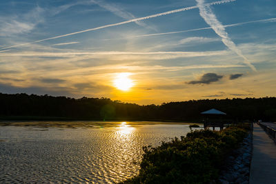 Scenic view of lake against sky during sunset