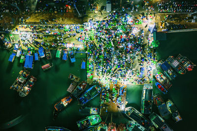 Aerial view of illuminated harbor in city at night