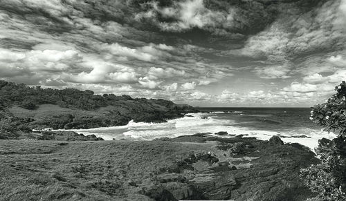 View of beach against cloudy sky