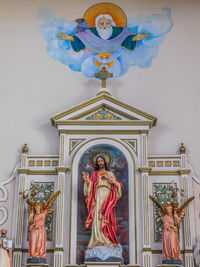 Low angle view of angel statue against building