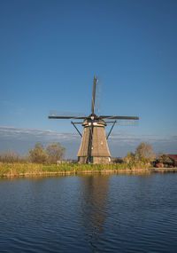 Ancient windmill on the edge of the canal at kinderdijk, netherlands