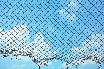 Low angle view of fence against sky