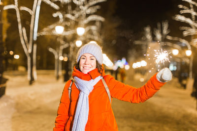 Portrait of woman standing in snow