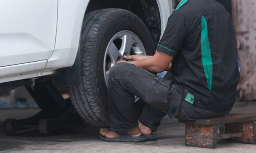 Low section of man holding car