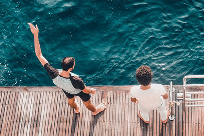 Rear view of people at swimming pool