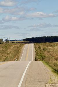 Road by landscape against sky