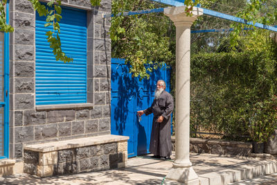 Full length of man standing against built structure