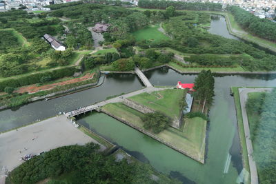High angle view of canal by agricultural landscape