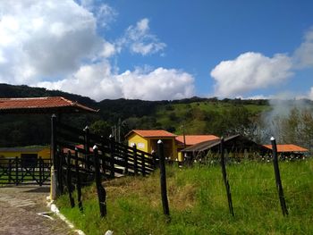 Built structure on field against sky