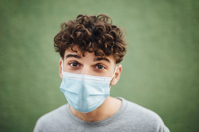 Portrait of young man against white background