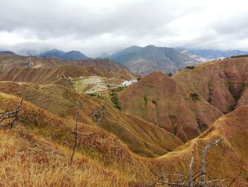 Scenic view of mountains against cloudy sky